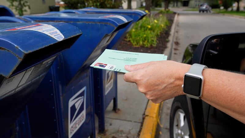 FILE - In this Tuesday, Aug. 18, 2020 file photo, a person drops applications for...