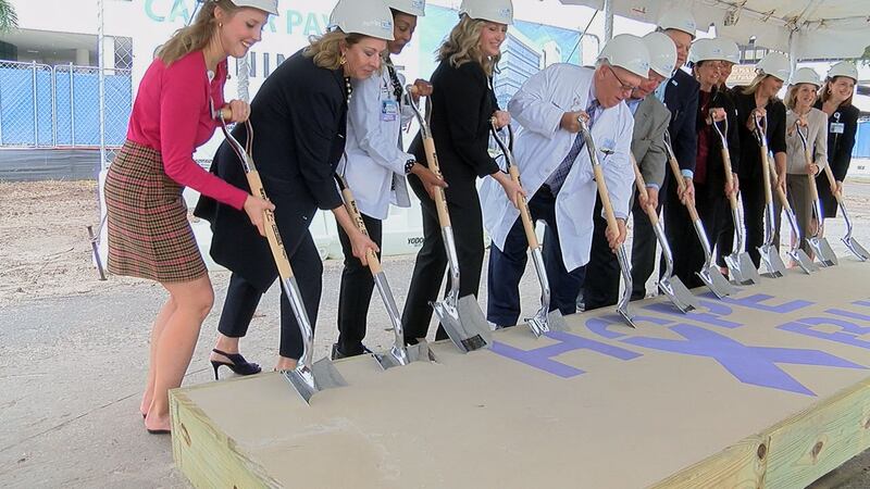 Sarasota Memorial doctors, staff, and community members dig up dirt to break ground on their...