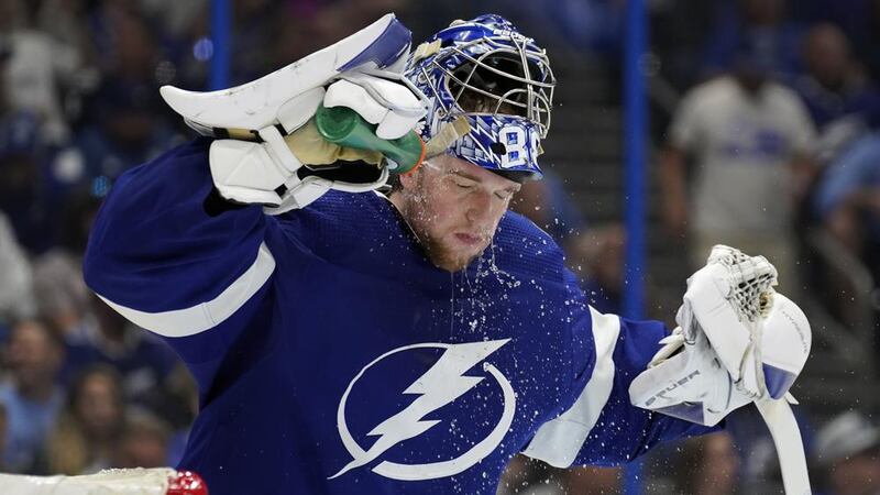 Tampa Bay Lightning goaltender Andrei Vasilevskiy (88) sprays water on his face during a...