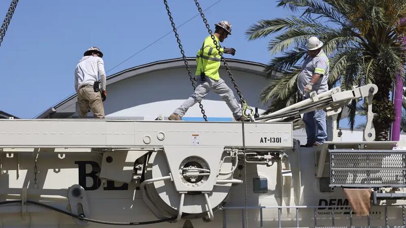 Work crews assemble the cranes that will be used to dismantle the Orlando FreeFall at ICON...