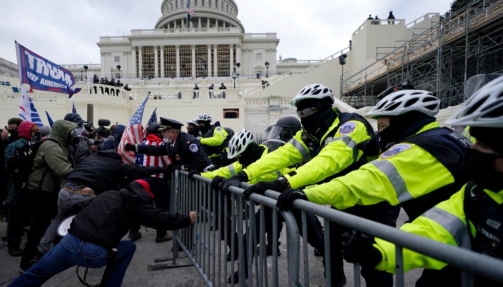 FILE - Supporters of President Donald Trump try to break through a police barrier, Wednesday,...