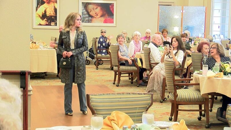 A woman in the Second Heart Homes program walks in the non-profit's fundraiser fashion show...
