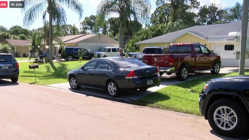 Police surround the home of the parents of Brian Laundrie Monday morning.