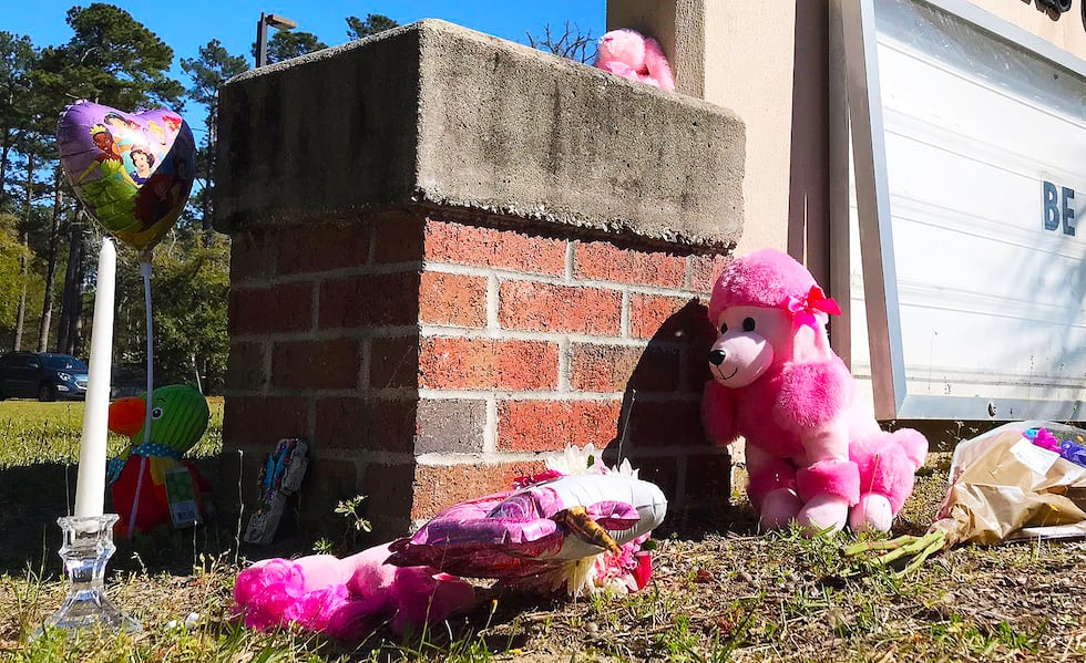 People were dropping off flowers, balloons and stuffed animals as part of a memorial to Raniya...