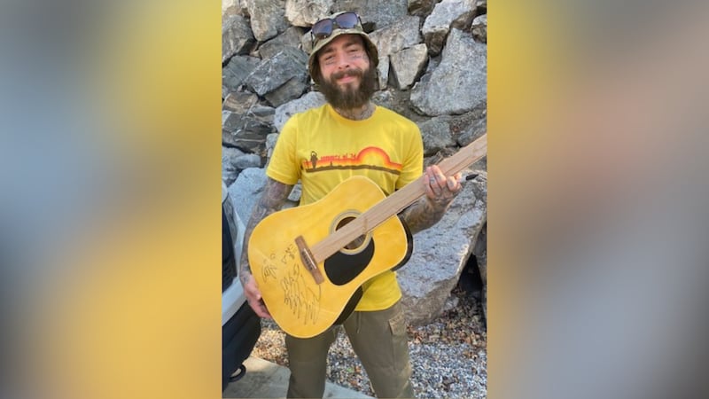 Post Malone has donated a signed guitar to help raise money for a nonprofit helping veterans.